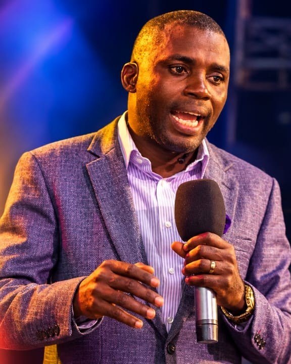 Pastor Segun Awolowo, Lead Pastor of The FirstWord Church, preaching with a microphone
